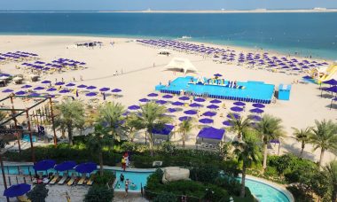 View from hotel room, beach with water slides and pools.