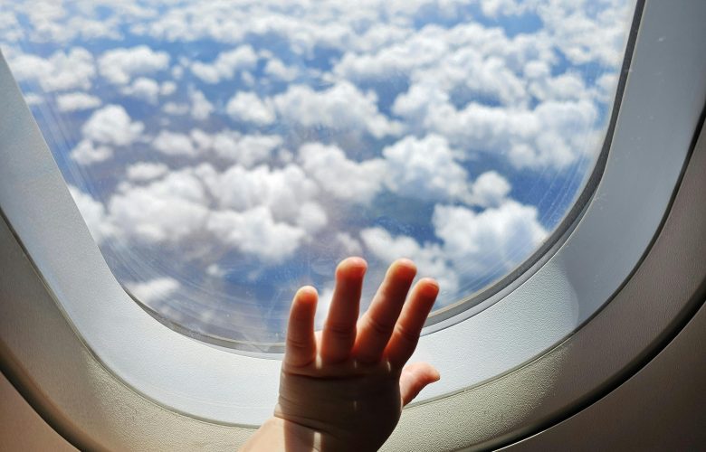 Toddler hand on airplane window