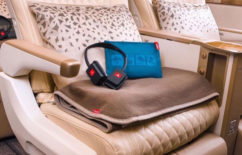 premium economy seat, with headphones and pillow