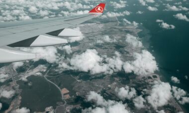 ariel image of a plane wing above the clouds