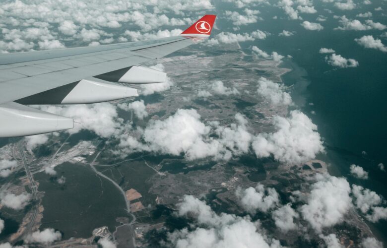 ariel image of a plane wing above the clouds
